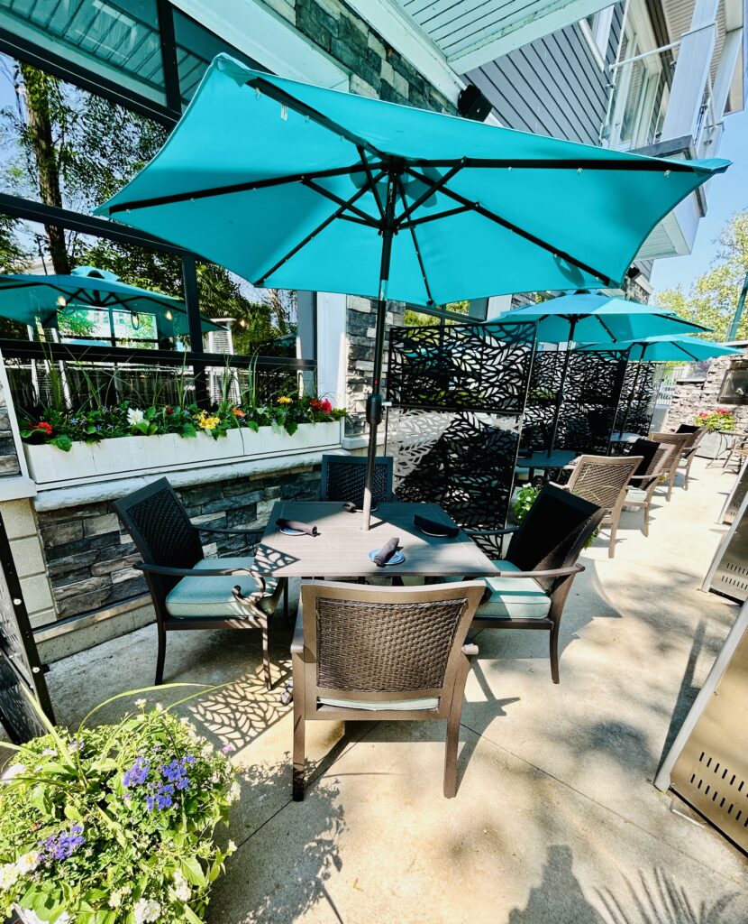 Elegant outdoor dining with river views and fireplaces