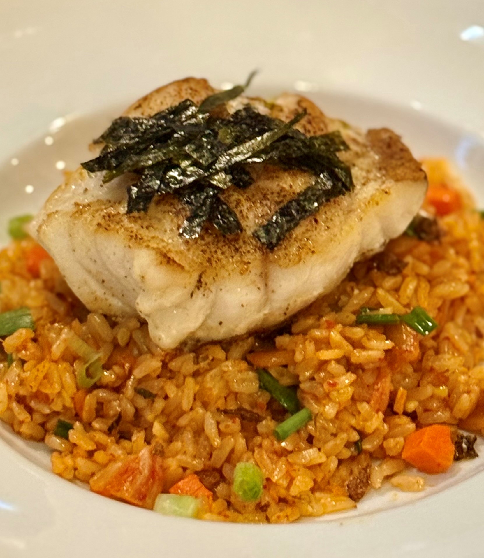Red Grouper over jasmine kimchi fried rice with toasted nori at The Tasting Room Traverse City, fine dining riverside