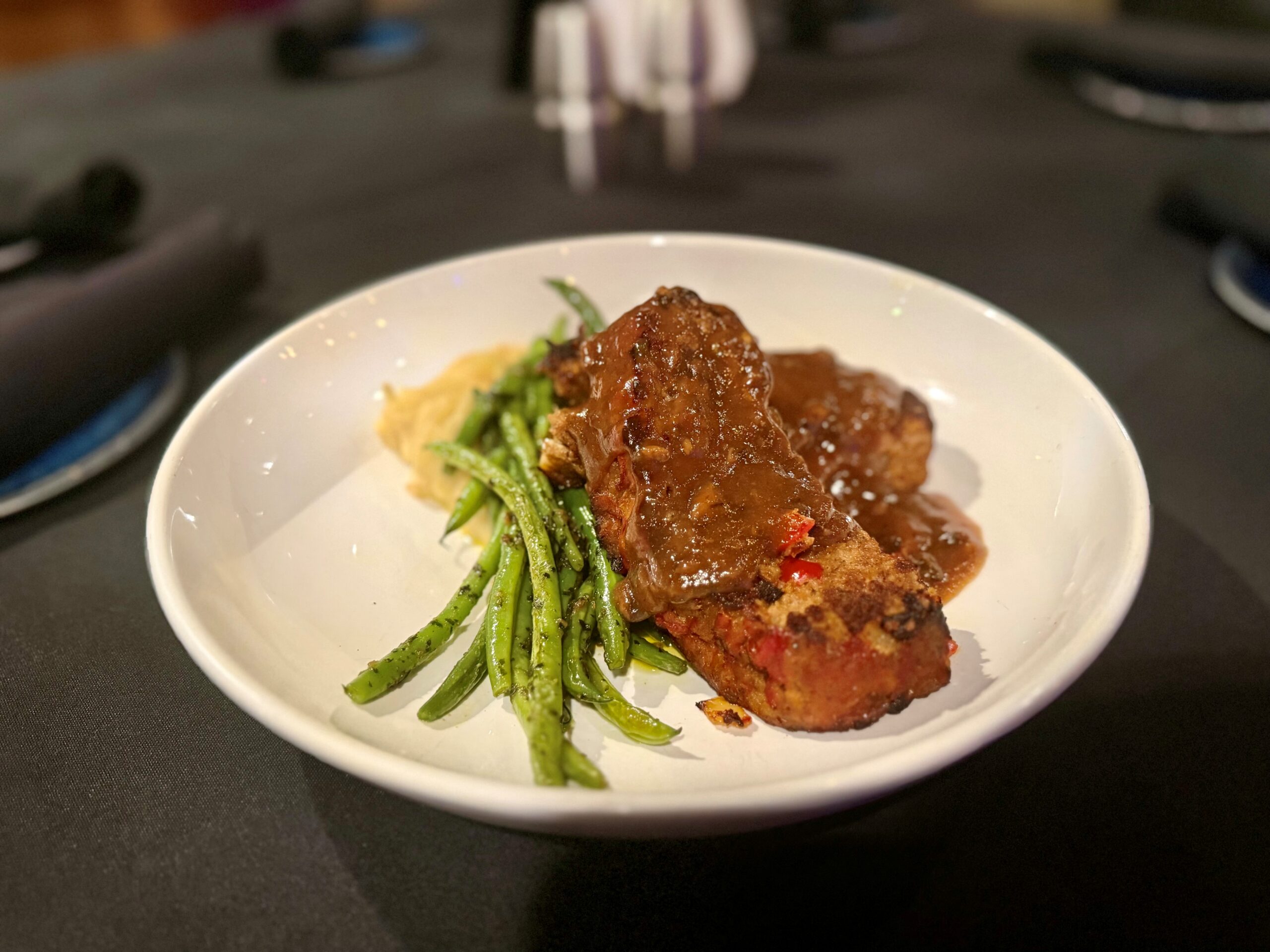 Signature tenderloin meatloaf with 48-hour demi-glace, mashed potatoes, and pesto green beans at The Tasting Room in Traverse City.